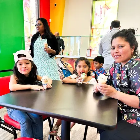 Kids eating ice cream cones at a Chicos table